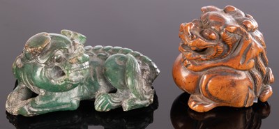 Lot 387 - A Japanese carved green jade recumbent Fu dog...