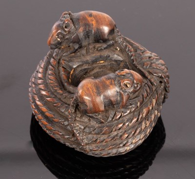 Lot 434 - A Japanese carved wooden netsuke, Meiji period,...