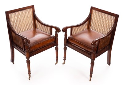 Lot 707 - A pair of Regency style walnut bergère...