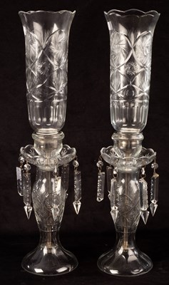 Lot 723 - A pair of cut glass candle holders, hung with...