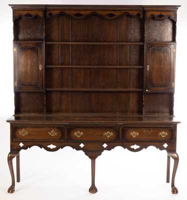 Lot 738 - A Georgian style oak dresser with closed rack...