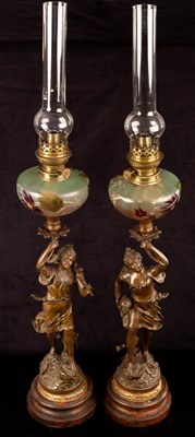 Lot 742 - A pair of figural spelter oil lamps, with...