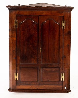 Lot 833 - A late 18th Century yew wood corner cupboard,...