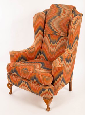 Lot 860 - A wing back armchair on dwarf cabriole front legs