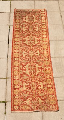 Lot 986 - A modern Pakistani runner with floral motif,...