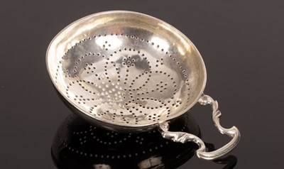 Lot 12 - A George III silver strainer with shaped handle
