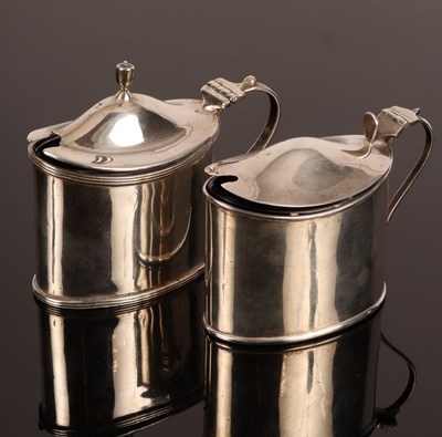 Lot 25 - An oval silver mustard pot with hinged cover,...
