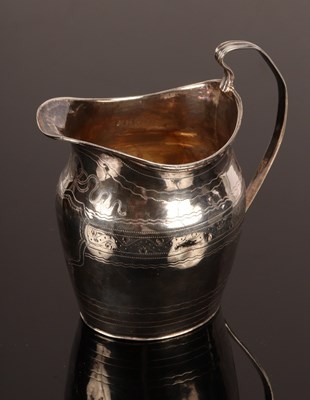 Lot 26 - A George III oval silver cream jug, London...