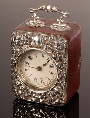 Lot 43 - An embossed silver mounted travelling clock...