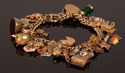 Lot 193 - An 18ct gold curb link charm bracelet, hung...