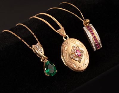 Lot 198 - A ruby and diamond set locket in 9ct yellow...