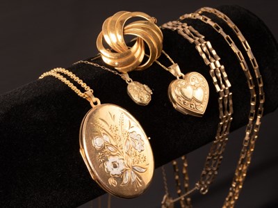 Lot 200 - Three 9ct gold lockets on fine link 9ct gold...