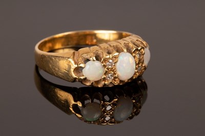 Lot 229 - An opal and diamond ring, set in 18ct yellow...