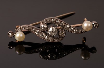 Lot 243 - A diamond and pearl bar brooch of scroll form...