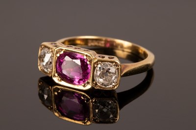 Lot 245 - A ruby and diamond three-stone ring, set in...