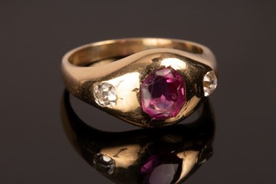 Lot 246 - A ruby and diamond three-stone ring in an...