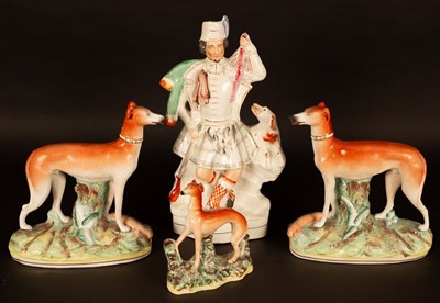 Lot 345 - A pair of Staffordshire greyhounds on oval...