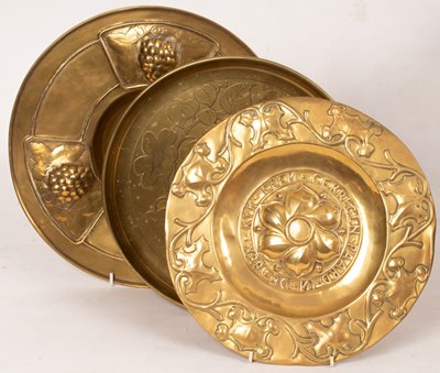 Lot 377 - An Arts & Crafts style brass charger decorated...