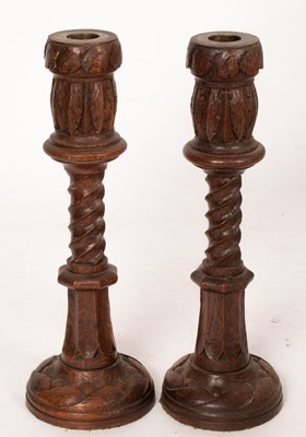 Lot 383 - A pair of turned oak candlesticks with leaf...