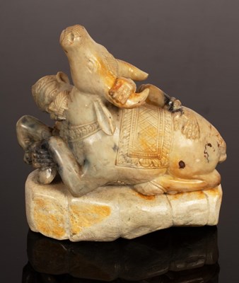 Lot 389 - A soapstone figure of a bull being attacked by...