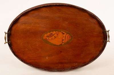 Lot 417 - An Edwardian oval mahogany tray with wavy rim...