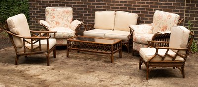 Lot 506 - A wicker garden furniture suite with cushions,...