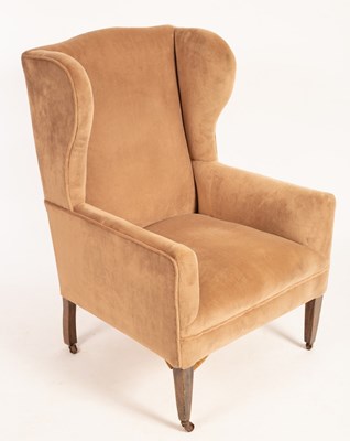 Lot 516 - A wing back armchair on square tapering front...