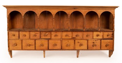 Lot 532 - A pine spice rack with a seven-arch top,...