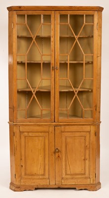 Lot 535 - A pine corner cupboard with twin glazed doors...