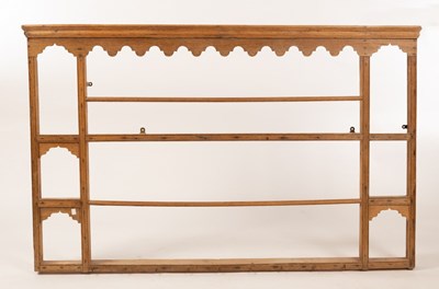 Lot 552 - A pine hanging shelf with shaped apron to the...