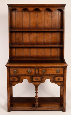 Lot 559 - A small oak dresser with shelves over, fitted...