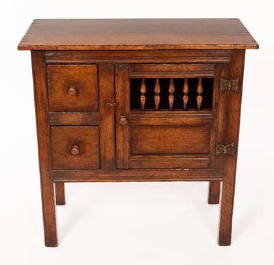 Lot 568 - An oak cupboard enclosed by a spindle turned...