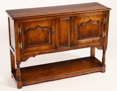 Lot 569 - A small oak cupboard enclosed by two fielded...