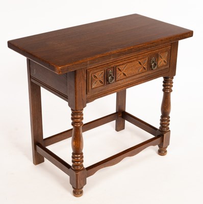 Lot 572 - A rectangular oak table, fitted a drawer on...