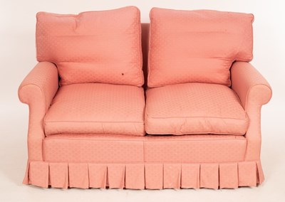 Lot 575 - A two-seater sofa upholstered in pink, fitted...