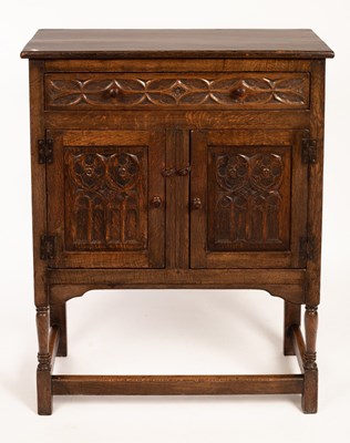 Lot 583 - An oak cupboard enclosed by a pair of carved...