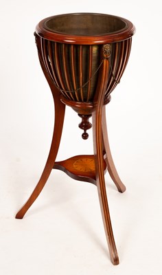 Lot 584 - An Edwardian mahogany slatted jardinière, on...