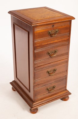 Lot 595 - A small pedestal chest of four drawers, on bun...