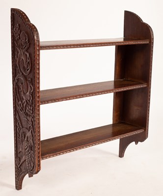 Lot 600 - A set of carved oak hanging shelves, 64cm wide