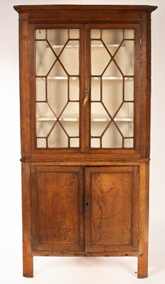 Lot 631 - An oak floor standing corner cabinet, the...