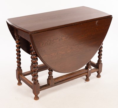 Lot 635 - An oak gateleg table on twist turned supports,...