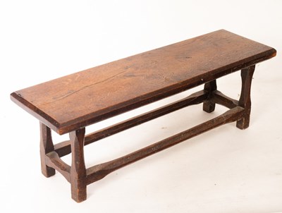 Lot 638 - A low oak stool, the top 75cm x 22cm, a 17th...