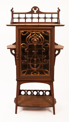 Lot 643 - An Art Nouveau music cabinet, the glazed doors...