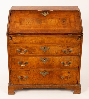 Lot 658 - A Queen Anne walnut bureau, the fitted...