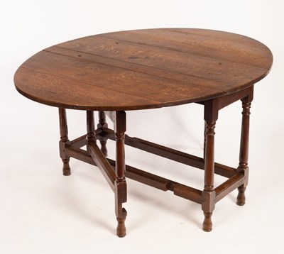 Lot 671 - A 18th Century oak drop-leaf dining table, the...