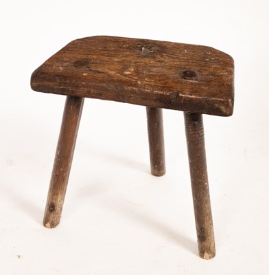 Lot 690 - An oak dairy stool, 40cm high