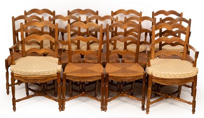 Lot 701 - A set of thirteen French walnut rush seated...