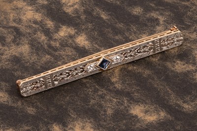 Lot 64 - An Edwardian style 14k yellow and white gold sapphire and diamond bar brooch