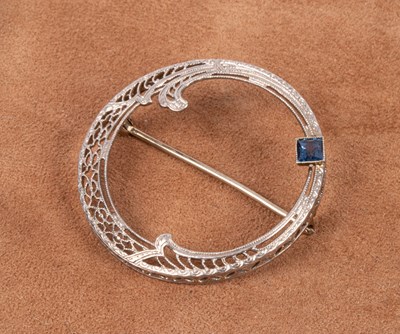 Lot 43 - An Art Deco style 14k white gold and sapphire circular brooch
