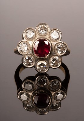 Lot 3 - A ruby and diamond cluster ring, set with a...